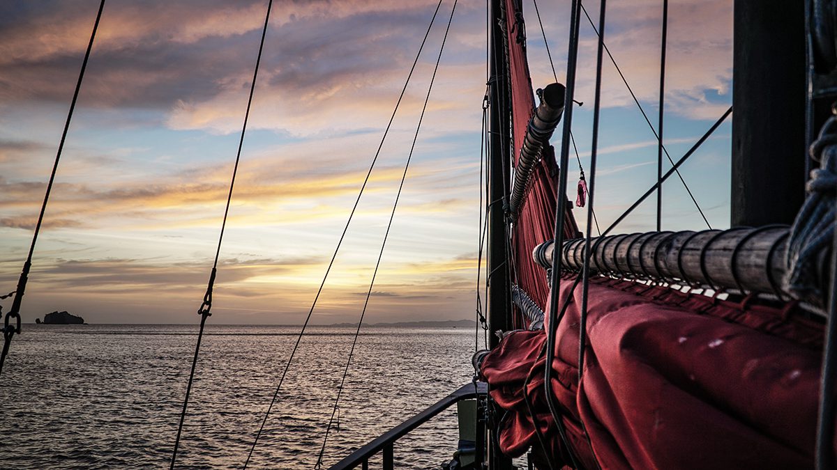 poc view of a krabi sunset from the wooden beams of a sail boat