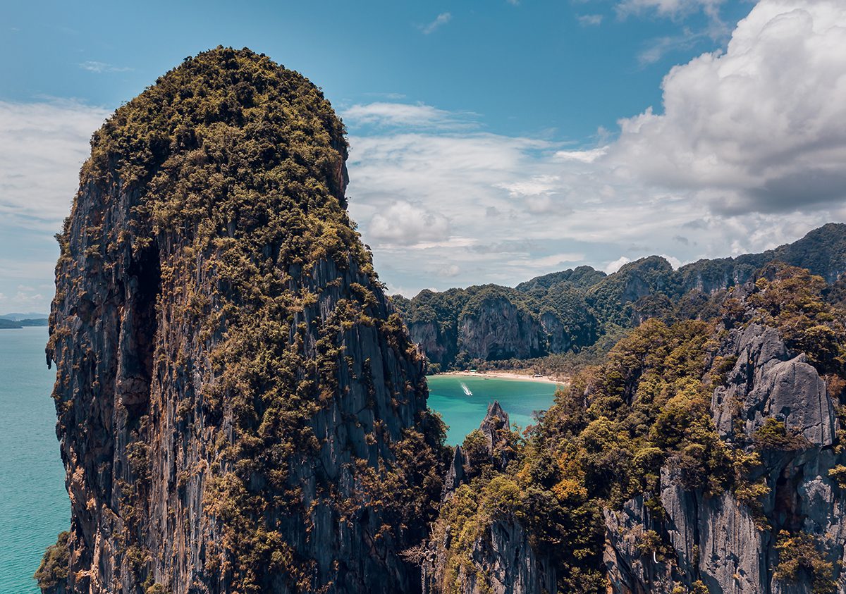 Railay limstone cliffs take from the top of one of the cliffs with a glimpse of Railay west beach between the rocks