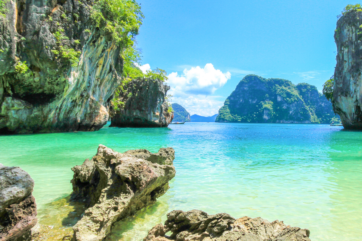 the blue seas of krabi taken from a rocky shoreline looking out across limestone islands