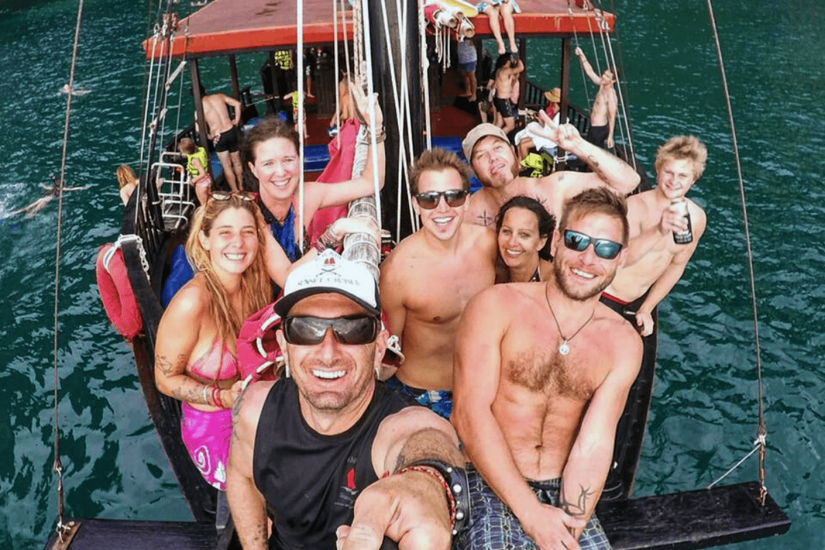 a selfie taken by Michael, the guide, of Krabi Sunset cruises with a mixed group of guests. the boat interior can be seen in the background
