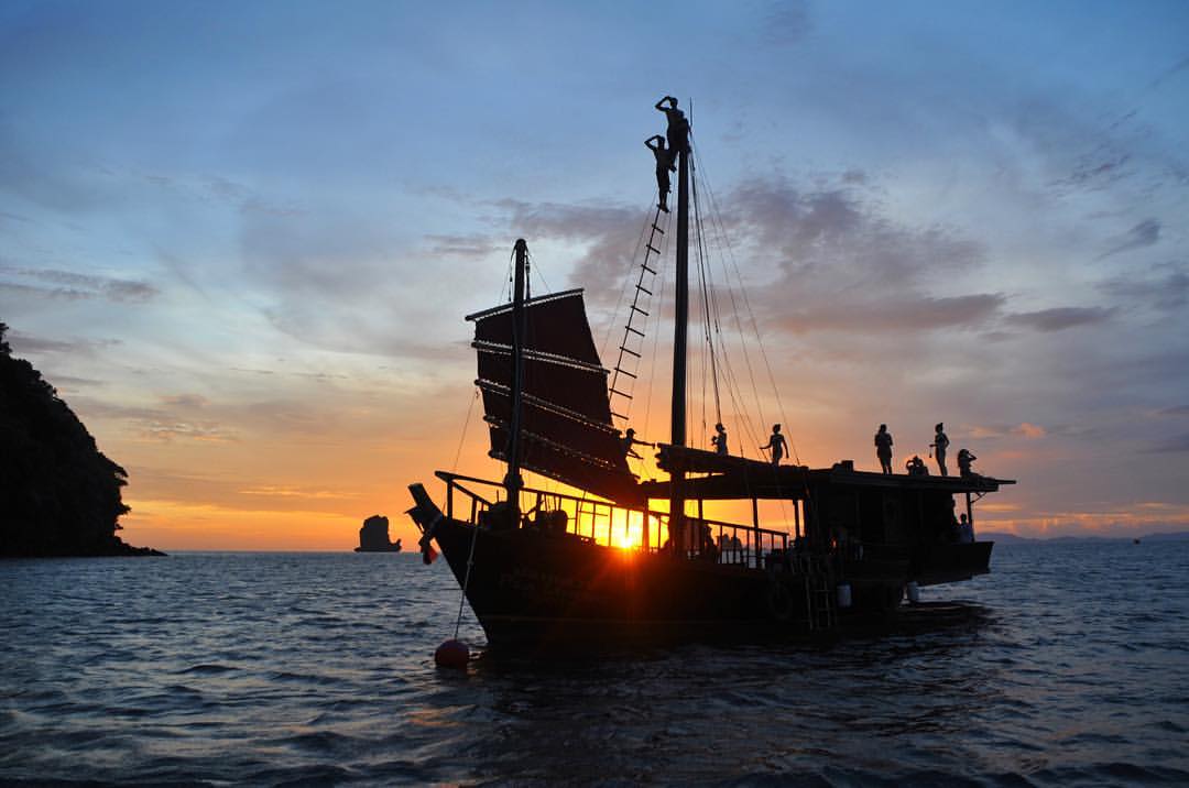 Silhoutte of Krabi Sailing Tour boat with the sunset in the background