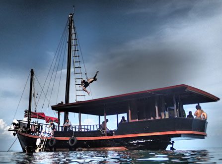 Guests onboard and jumping off boat during a Krabi Sunset Cruise