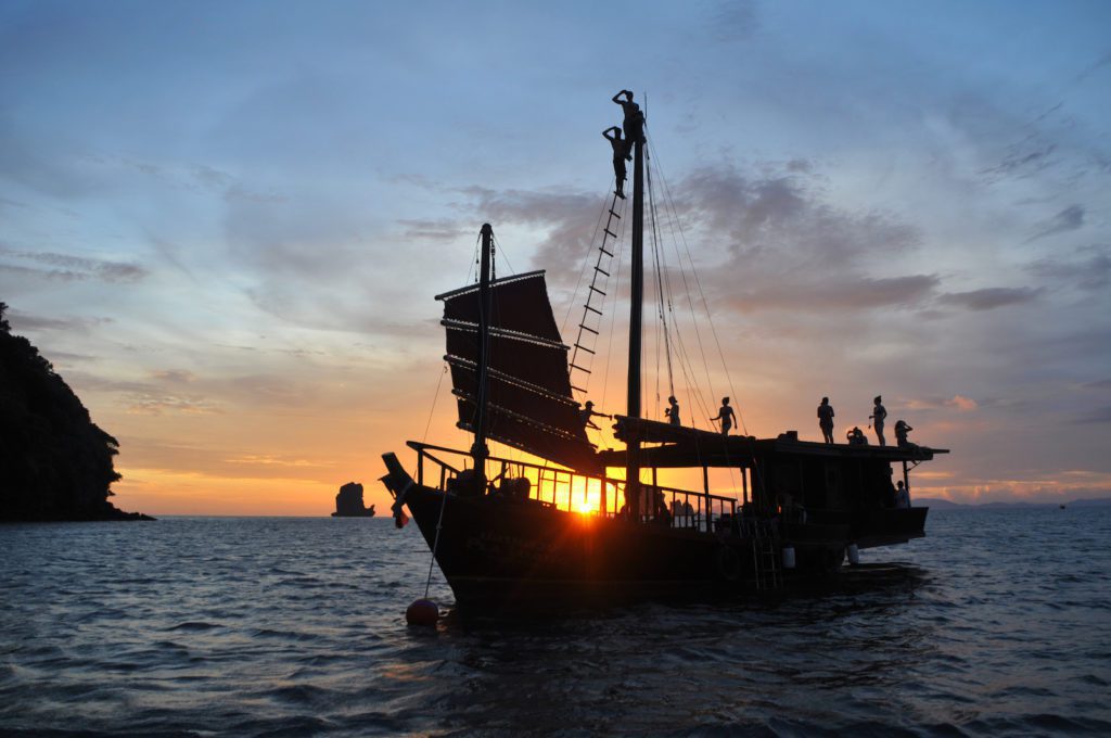 Silueta de gente viendo la puesta de sol desde un barco en Krabi