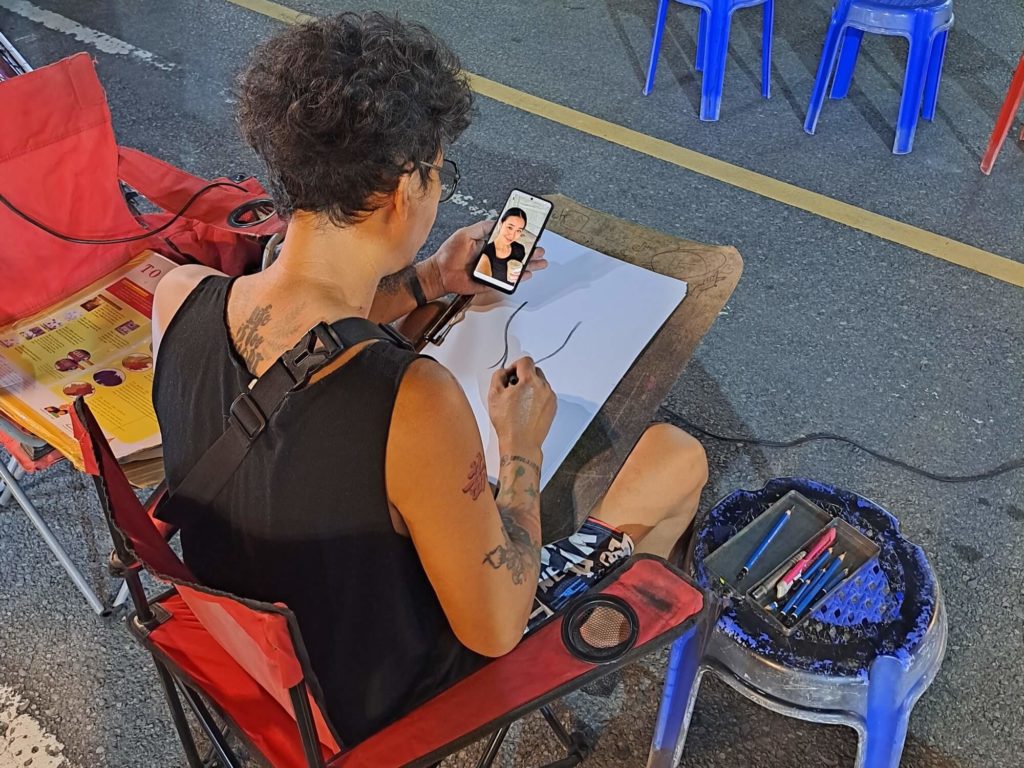 Krabi night market caricature artist