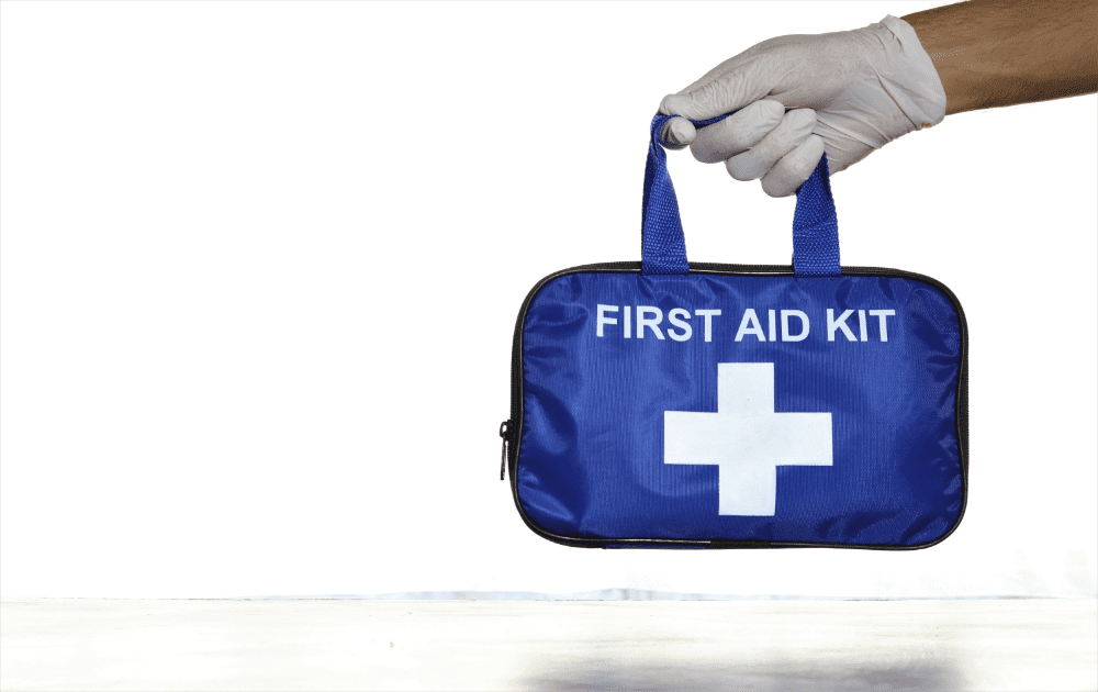 hand holding a blue first aid kit bag
