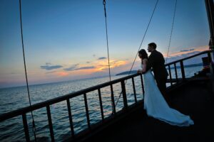 couple mlookingout to see after their krabi wedding on krabi sunset cruise thailand