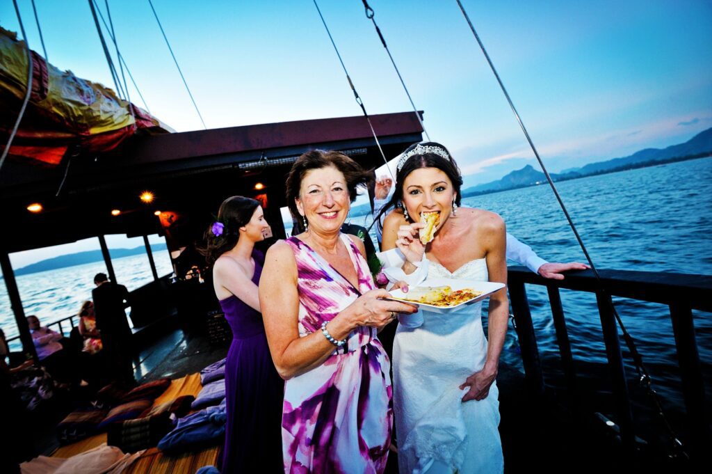 weddng buffet onboard krabi sunset cruises, two ladies eating from their plate