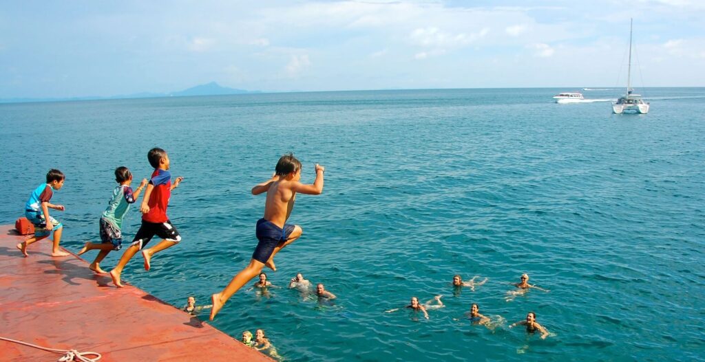 kids jumping off a boat tour in krabi 