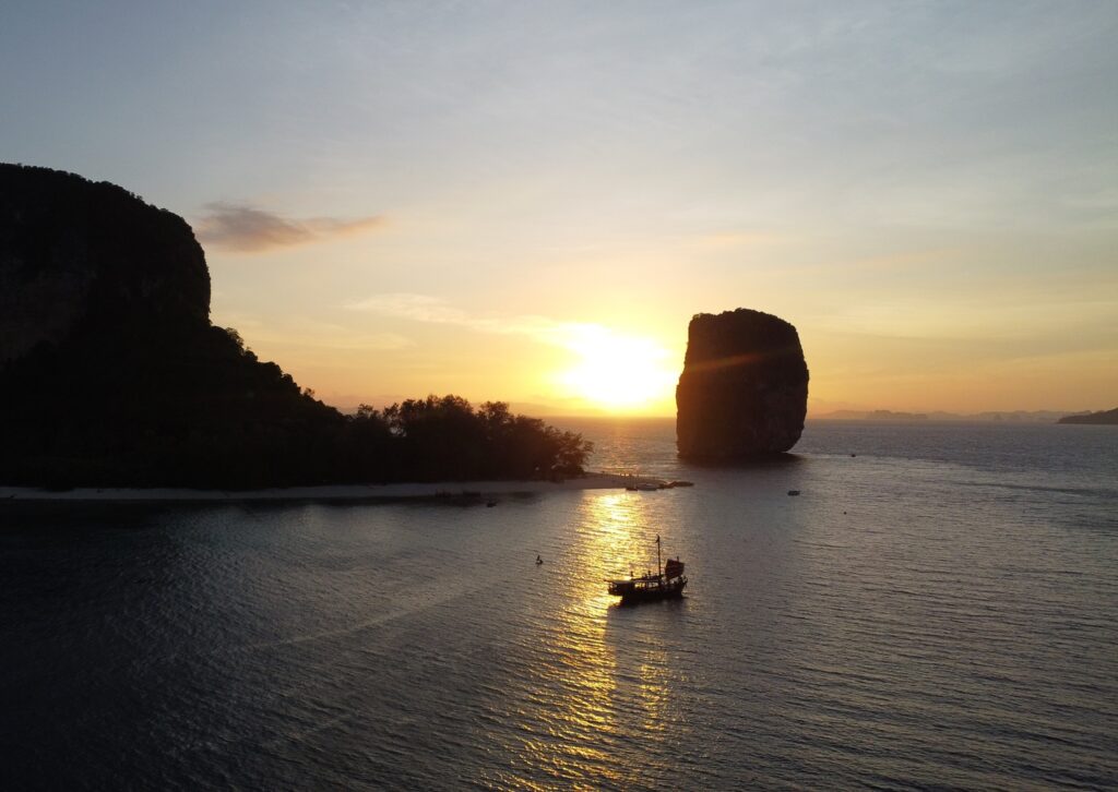 krabi sunset cruise boat sailing past poda island at sunset