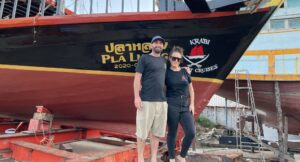 Michael and carolyn of krabi sunset cruises standing in front of their pirate boat