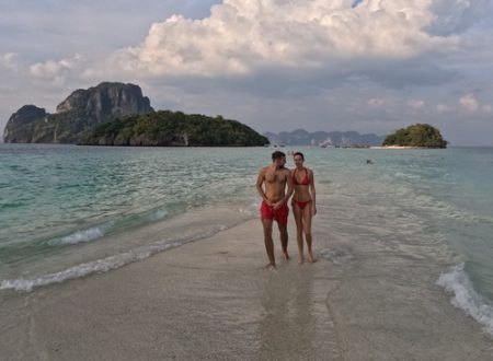 Couple standing on a sandbar surrounded by turquoise waters with koh Tup and Poda Island in the background