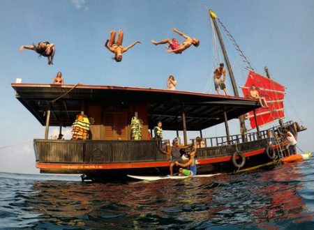 3 people jumping from the roof of krabi sunset cruises junk boat