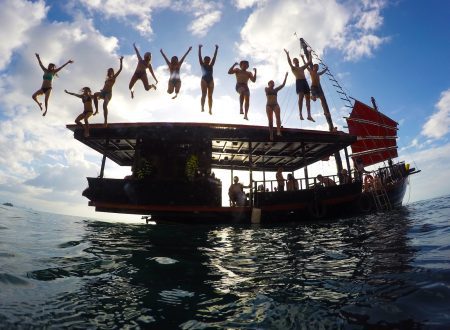 Silhouette of group jumping into sea from the Krabi Sunset Cruise boat